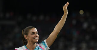 Alex Morgan waves to the crowd at her last game