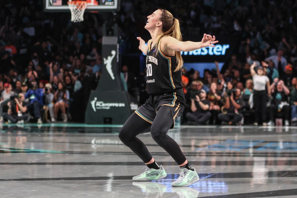 Liberty guard Sabrina Ionescu celebrates with her arms out like a bird