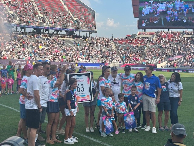 Alex Morgan and members of her family posing for a picture before her last game.