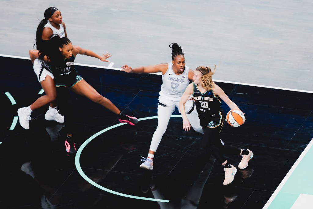 Betnijah Laney-Hamilton blocks out Jackie Young from Sabrina Ionescu's drive on Chelsea Gray