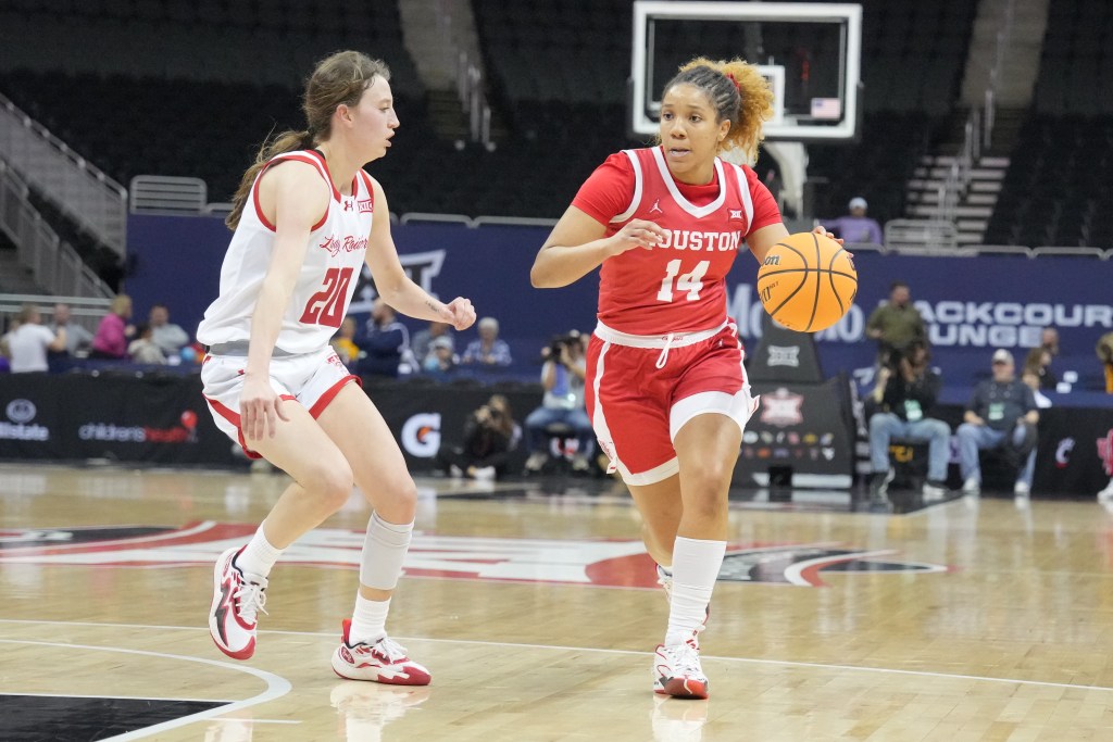 Houston guard Laila Blair dribbles just inside the 3-point line with her left hand.