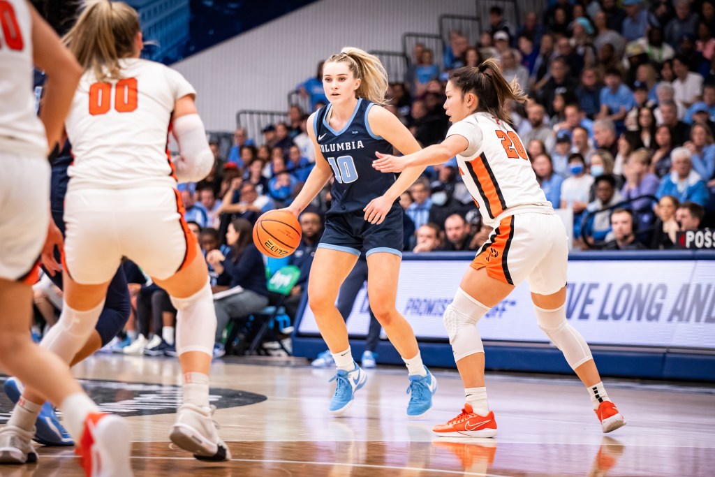Columbia guard Kitty Henderson dribbles the ball with her right hand on the perimeter and considers her options. Princeton guard Kaitlyn Chen slides her feet to defend Henderson.
Ivy League
