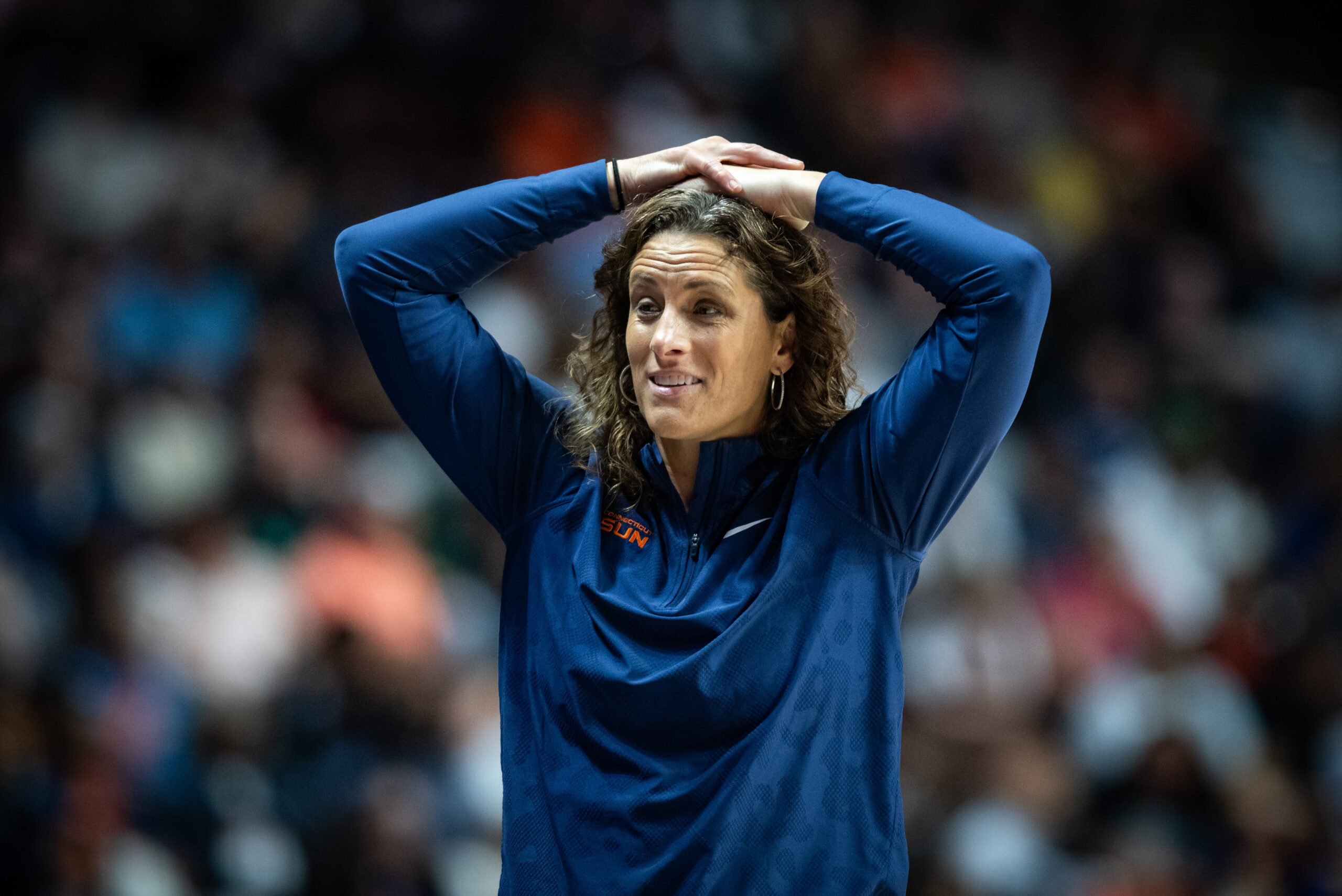 Connecticut Sun head coach Stephanie White places her hands on her head in frustration during a game.