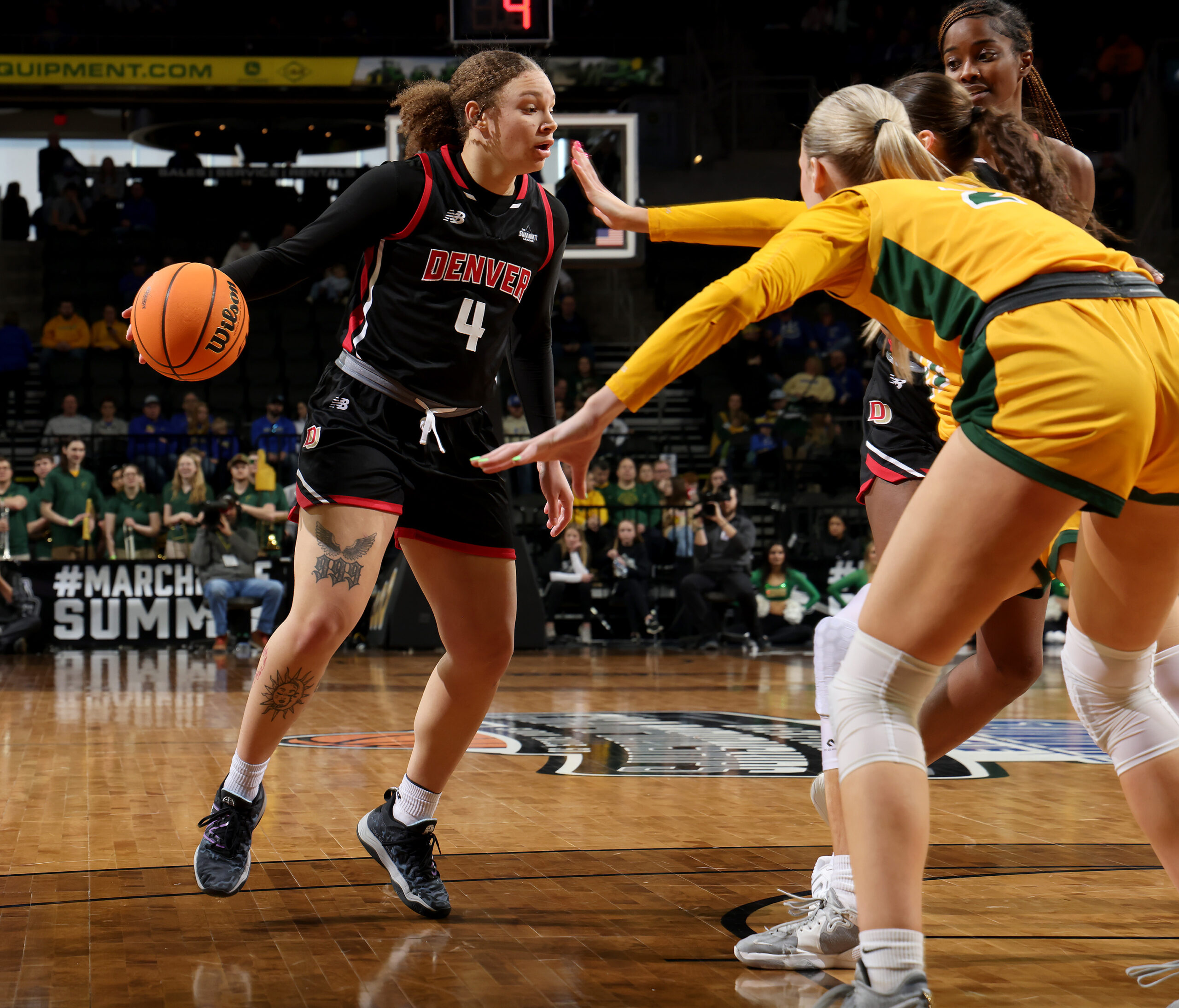 Jordan Jones dribbles the basketball for Denver.