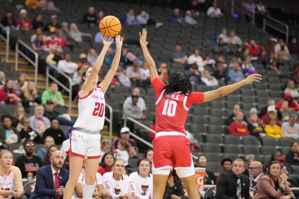 Texas Tech junior guard Bailey Maupin shoots a right-handed jump shot as a defender jumps to contest it.