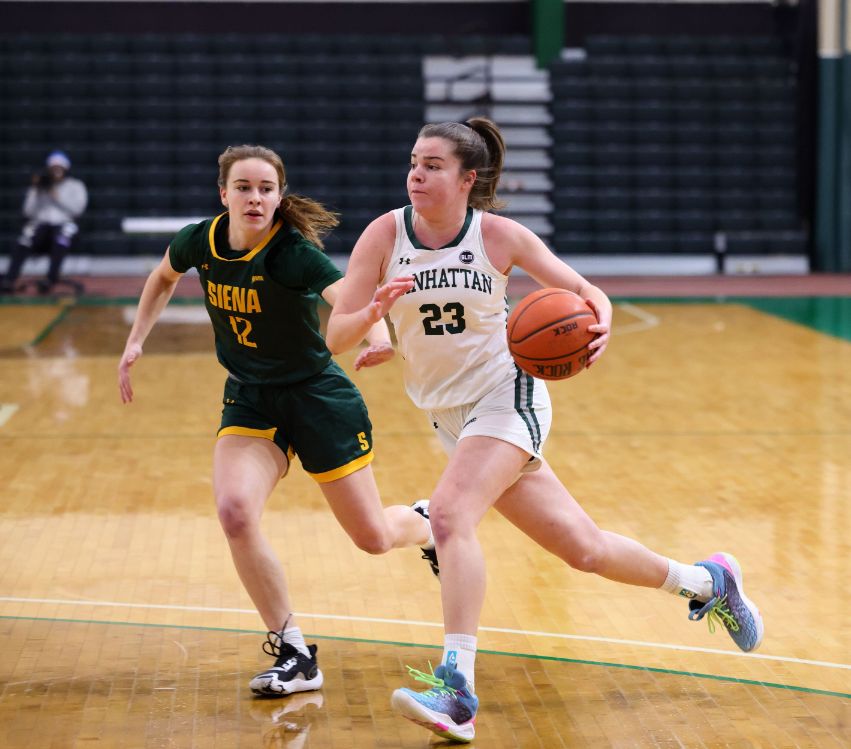 Manhattan guard Ines Gimenez Montserrat dribbles the ball with her left hand while running toward the basket.