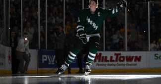 Boston forward Hilary Knight (21) skates onto the ice and waves to the crowd