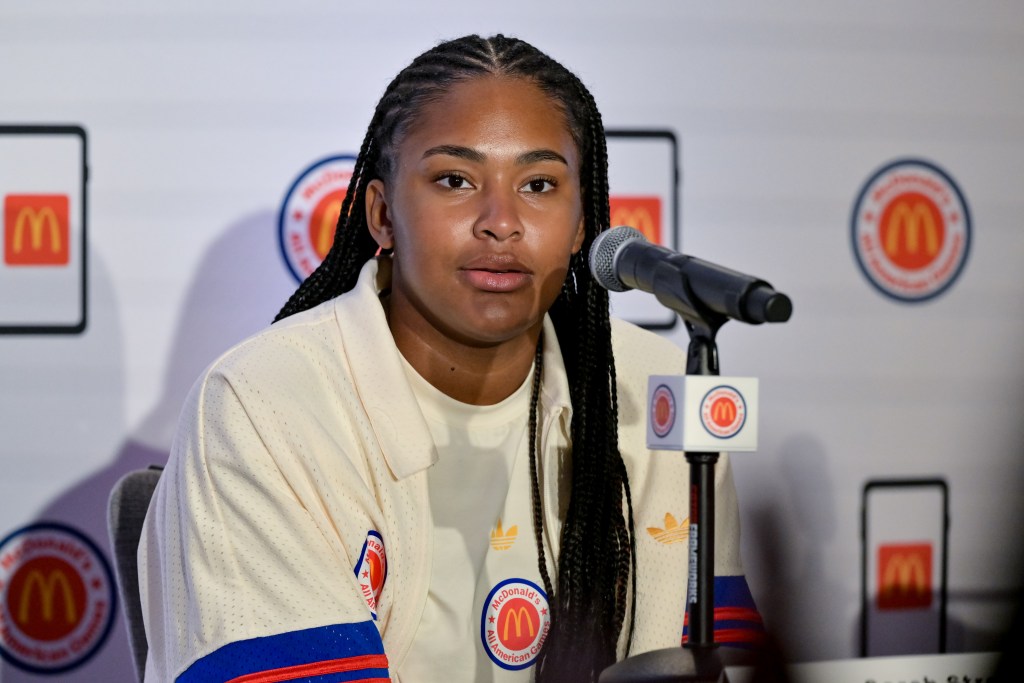 Sarah Strong addresses the media behind a microphone
BIG EAST