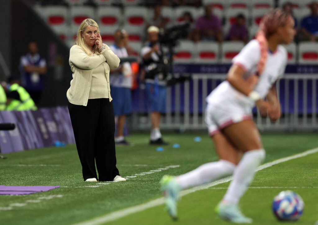 Emma Hayes watched in the background as play unfolds on the soccer field