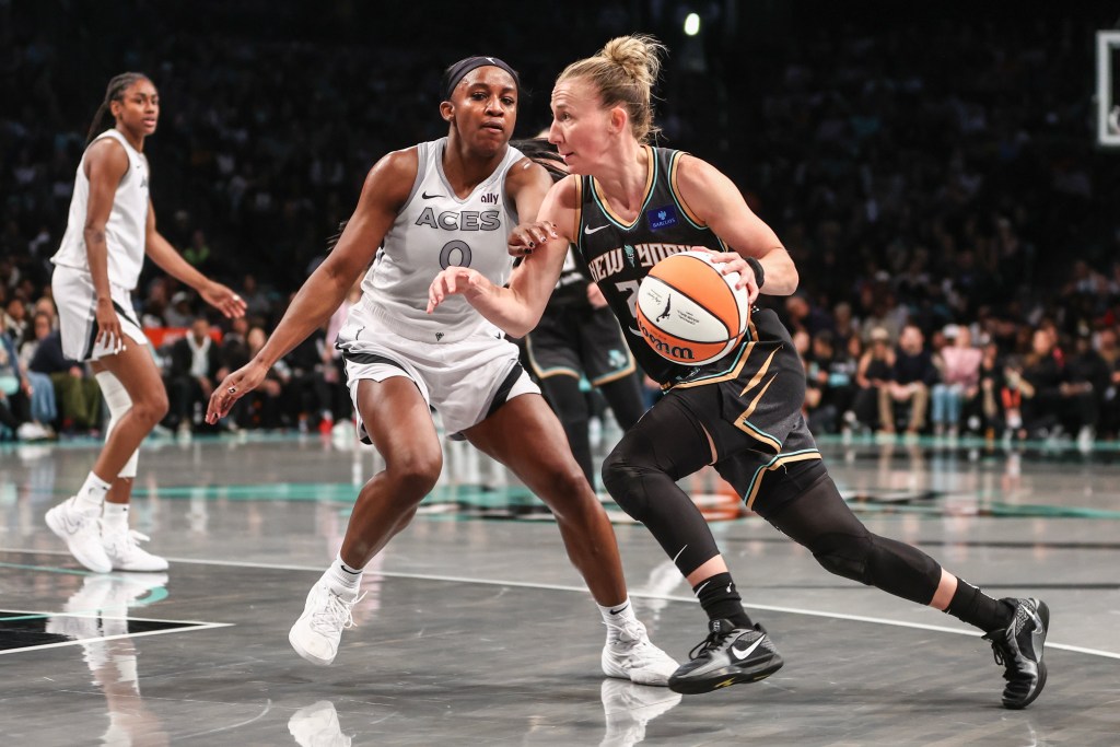 Courtney Vandersloot drives past Jackie Young 