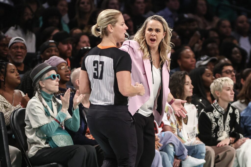 Becky Hammon discusses things with an official.