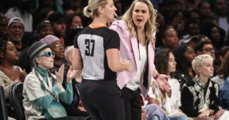 Becky Hammon discusses things with an official.