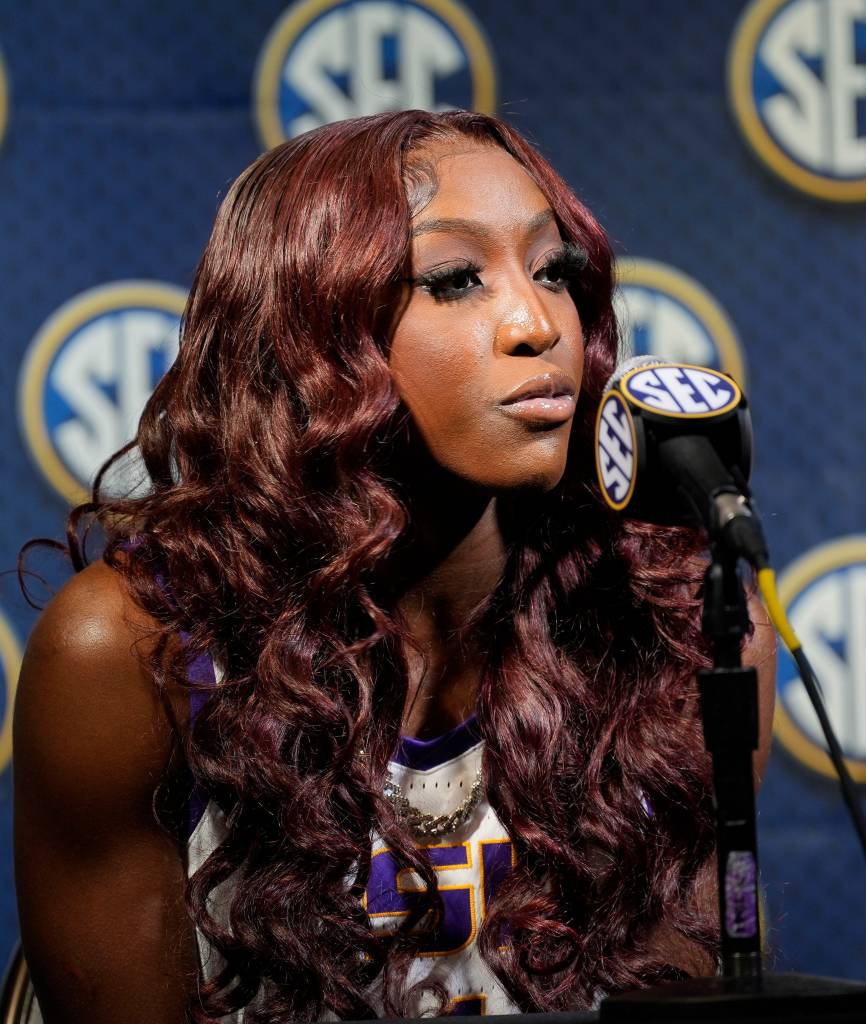 Flau'Jae Johnson sits at a podium and answers questions at SEC Media Day