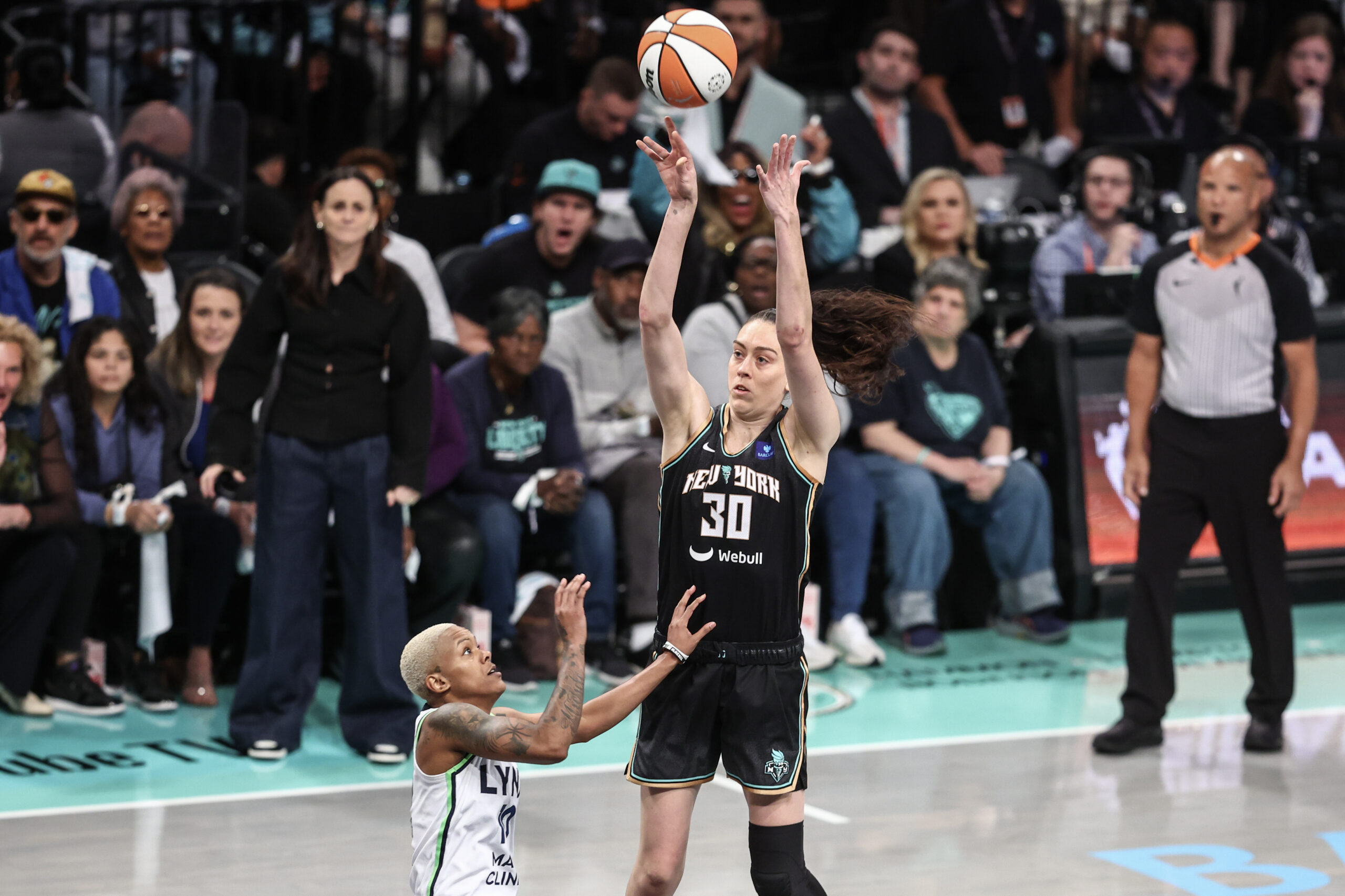 New York Liberty forward Breanna Stewart elevates for a jump shot over the smaller Courtney Williams of the Minnesota Lynx.
