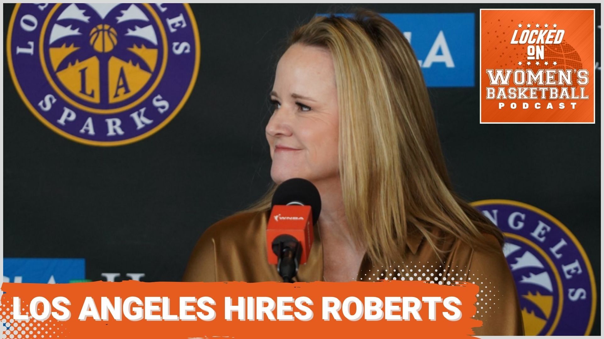 A photo of new Los Angeles Sparks head coach Lynne Roberts sitting at a table with a podium microphone for her introductory press conference. The text "Los Angeles hires Roberts" is overlaid at the bottom in all caps, and the orange Locked On Women's Basketball logo is in the top right corner.