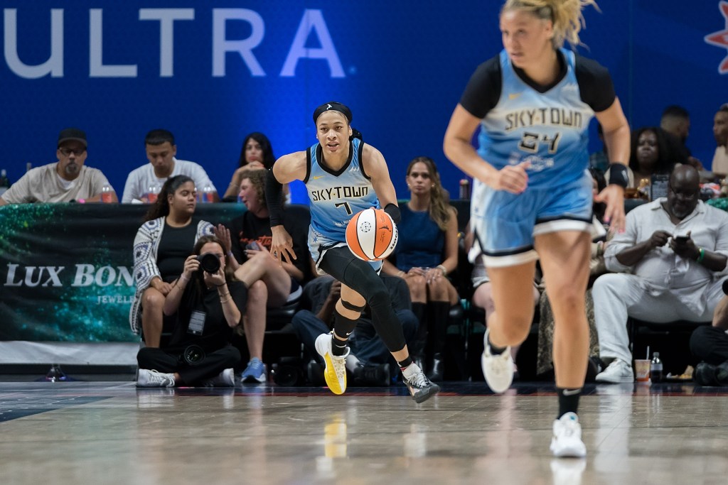 Chennedy Carter dribbles the ball up the court while Rachel Banham runs up the sideline