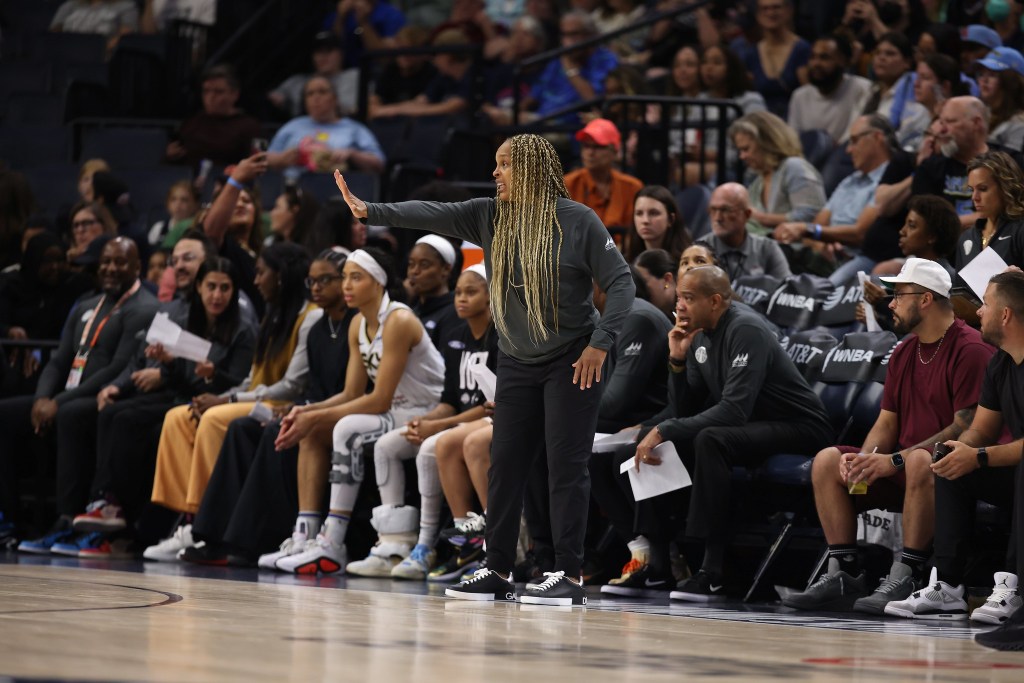 Then-Chicago Sky head coach Teresa Weatherspoon extends her right arm straight out in front of her with her palm out, as if making a "stop" sign.