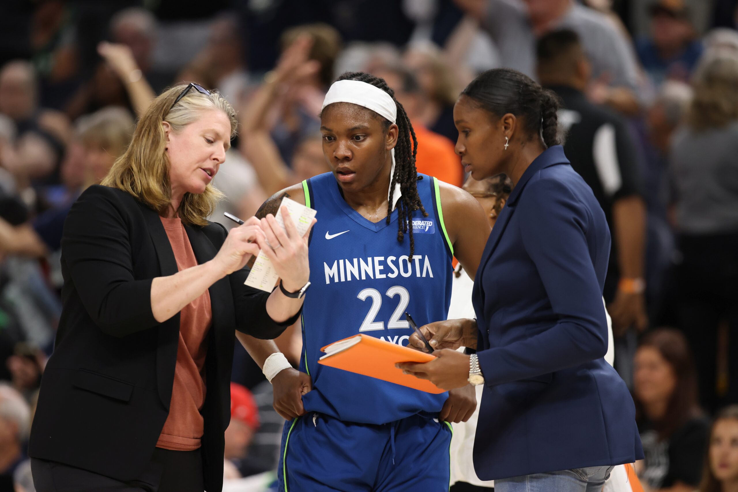 Lynx assistant coaches Katie Smith and Rebekkah Brunson chat with Myisha Hines Allen during a timeout