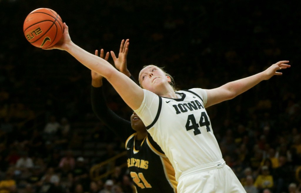 Addison O'Grady extends her right arm to try to secure a rebound.