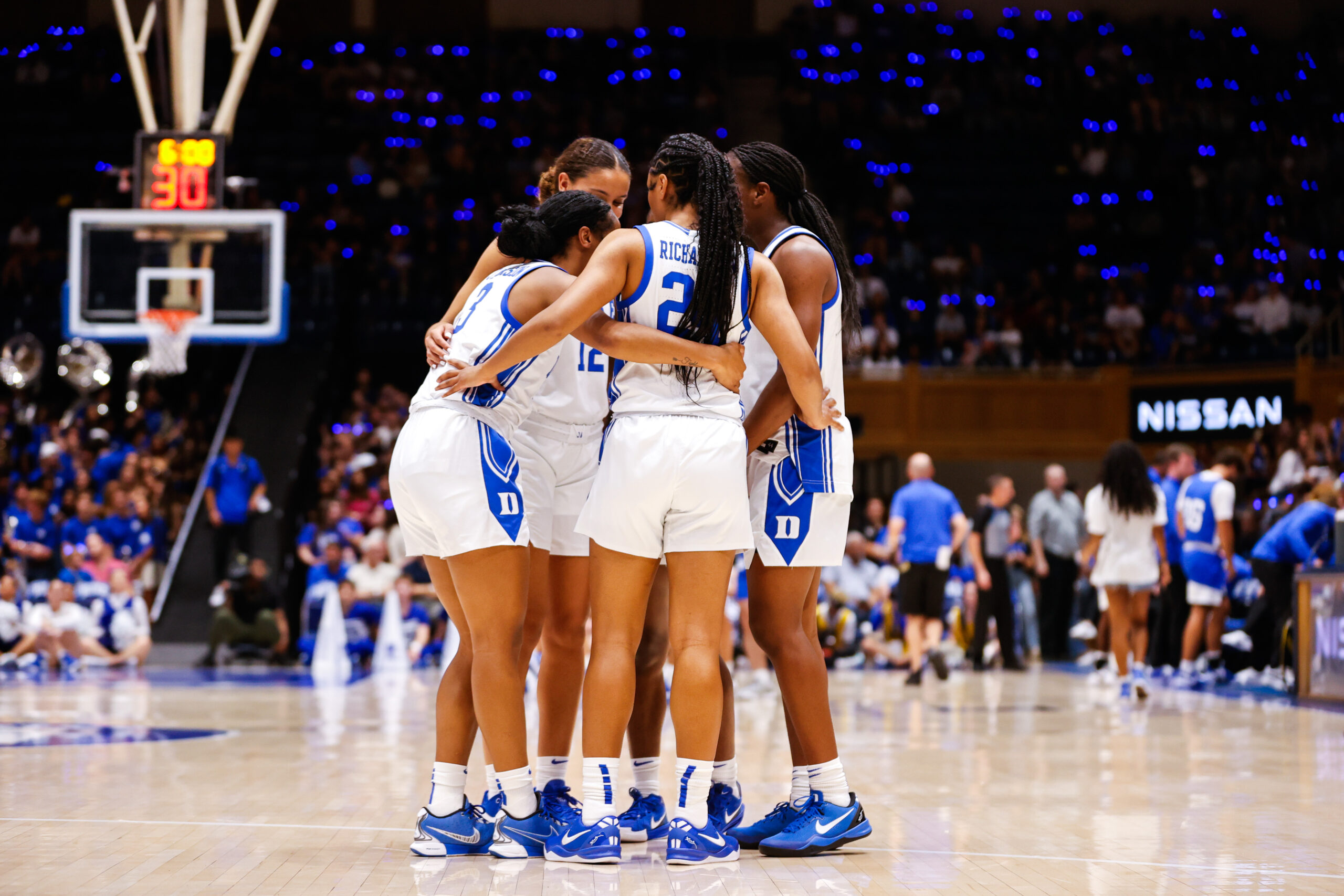 Duke Blue Devils Women’s Basketball Team huddles during Countdown to Craziness at Cameron Indoor Stadium in the middle of the court in front of a packed crowd