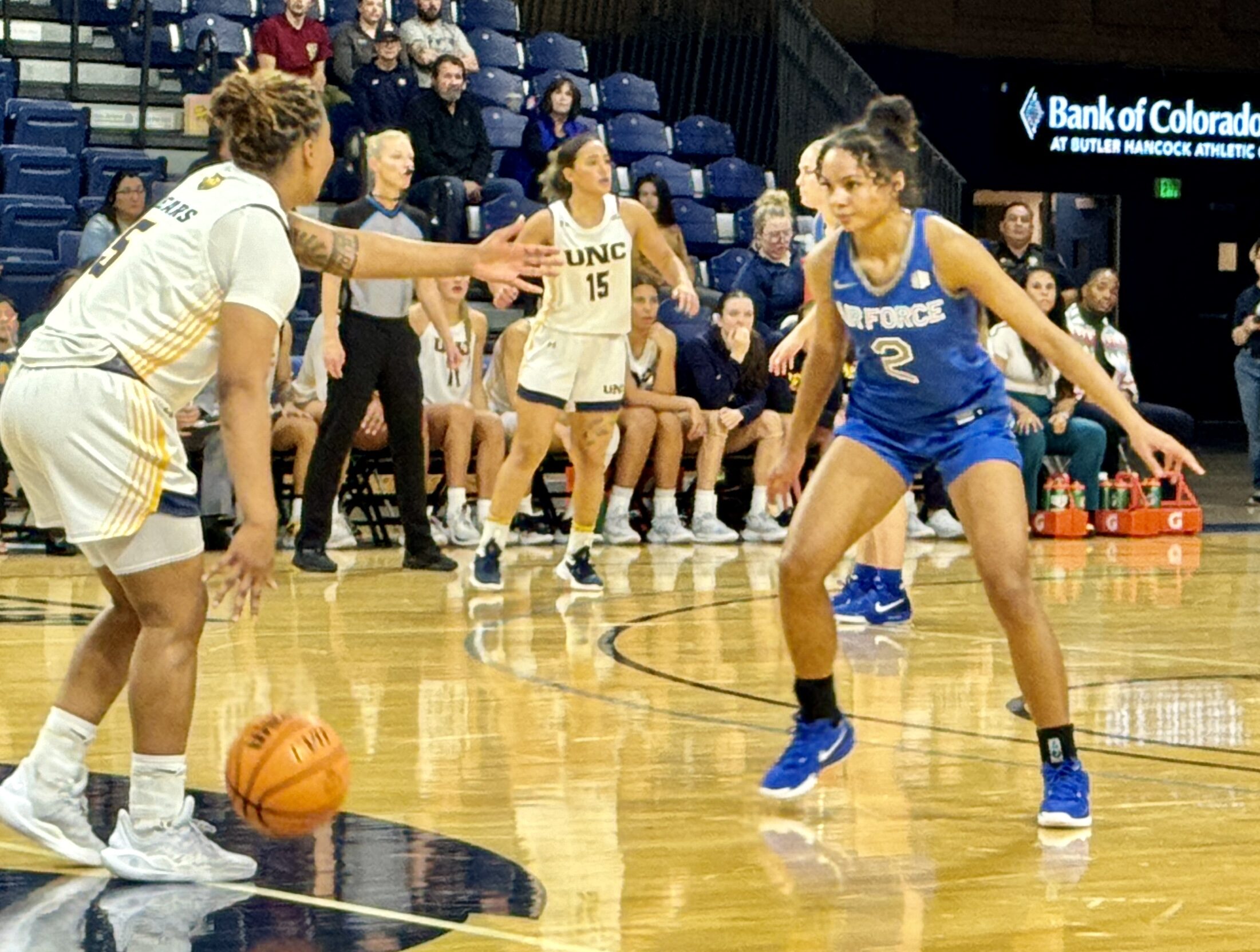 Air Force guard Milahnie Perry closely defends Northern Colorado guard Neenah George as she brings the ball up the court.