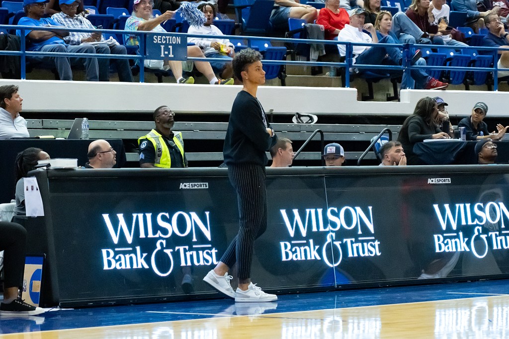 Tennessee State head coach Candice Dupree stands on the sidelines during a game with her arms folded across her chest.