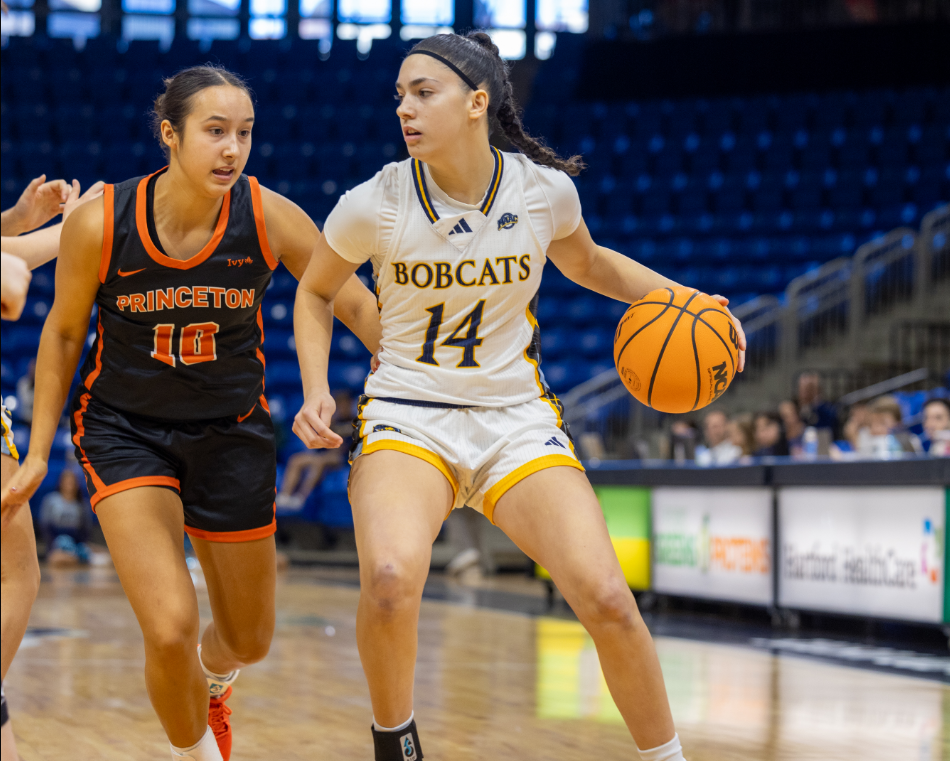 Gal Raviv dribbles with her left hand while looking forward and Princeton guard Skye Belker is pursuing her