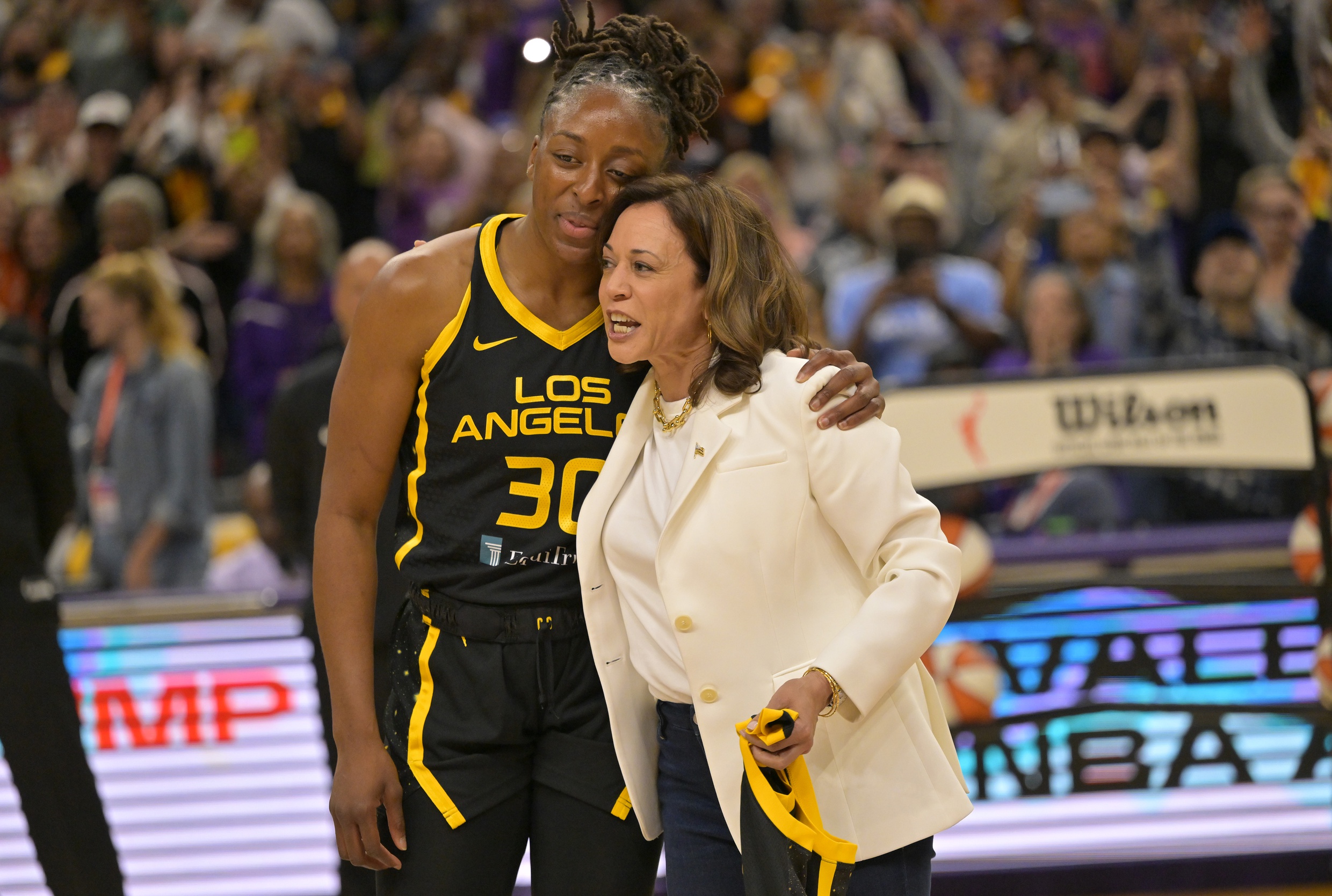 Nneka Ogwumike and Kamala Harris embrace.