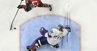 Aerial photo of Team Canada forward Emma Maltais in on a breakaway towards a Team USA goalie