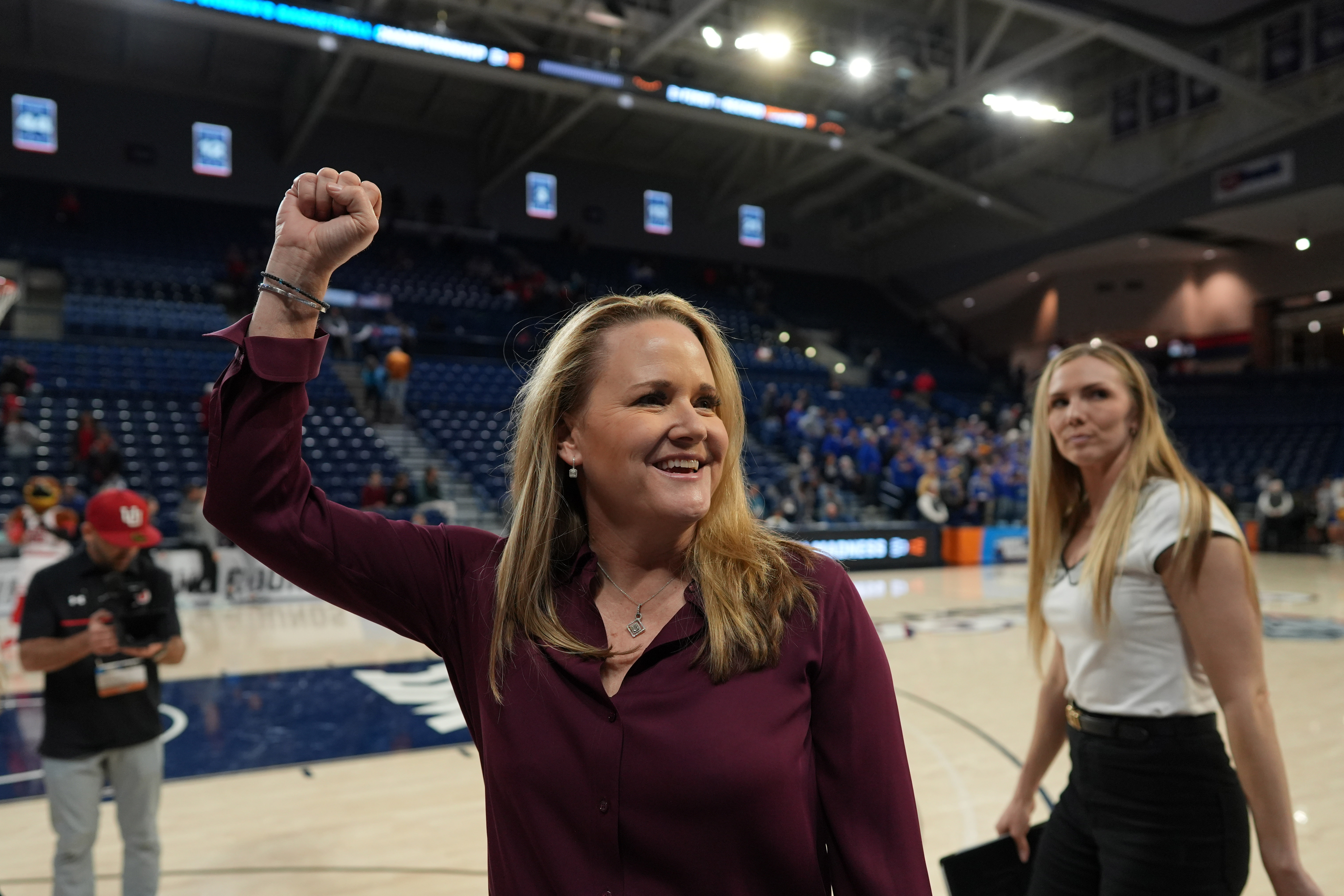 Lynne Roberts pumps her fist in the air after a victory in the 2024 NCAA Tournament.