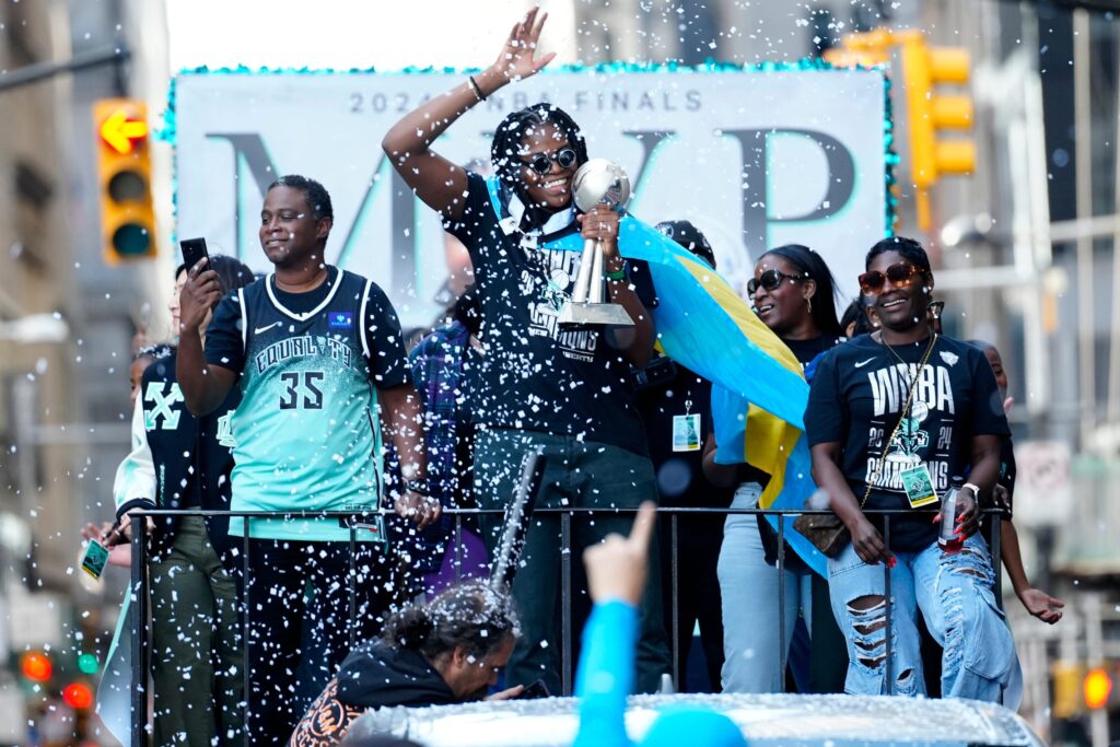 Jonquel Jones and company, celebrated at a parade.