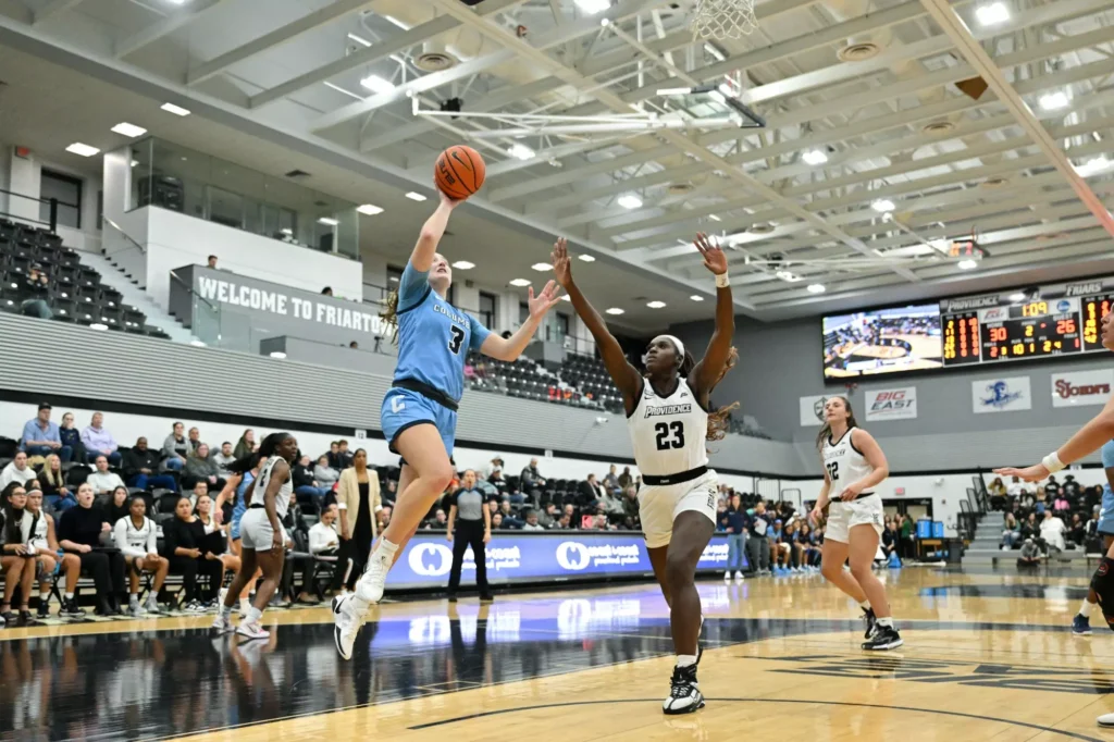 Columbia guard Cecelia Collins shoots an open right-handed layup as a Providence defender arrives too late to contest it.
