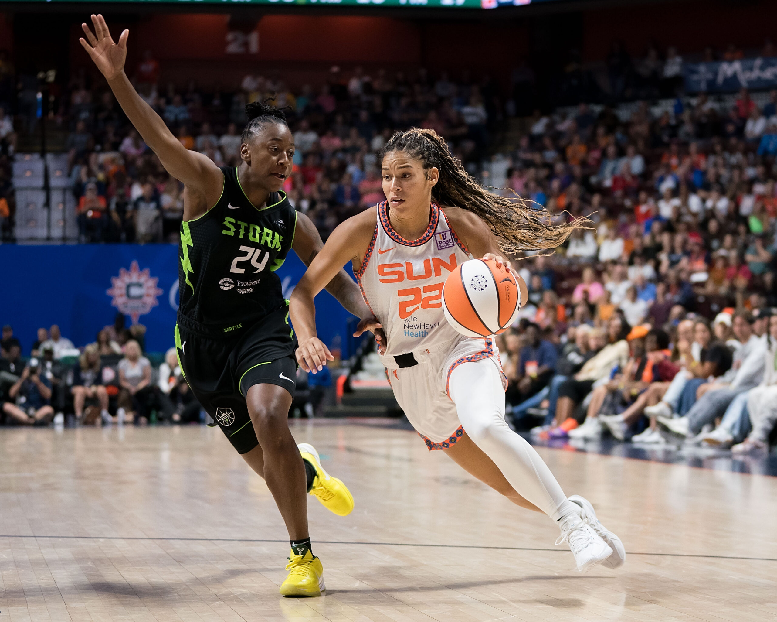 Veronica Burton dribbles basketball as she drives to the basket.