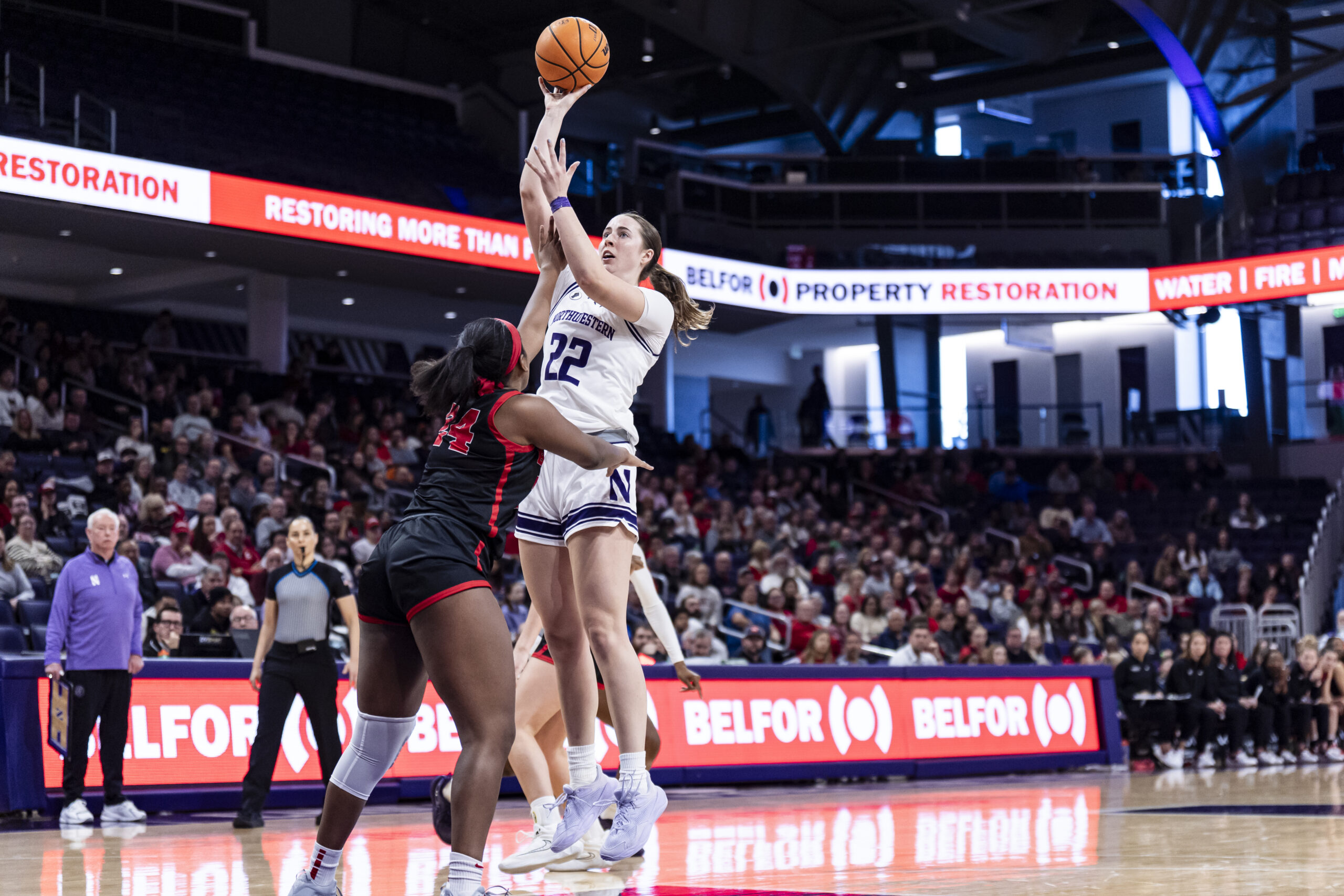Grace Sullivan floats up a shot for Northwestern as Cornell's Summer Parker-Hall puts her left hand up to contest it.