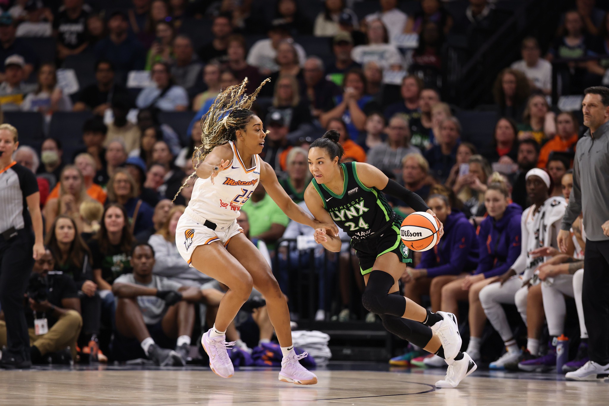 Phoenix Mercury forward Monique Billings slides her feet to defend Minnesota Lynx forward Napheesa Collier, who is trying to drive the ball with her left hand.