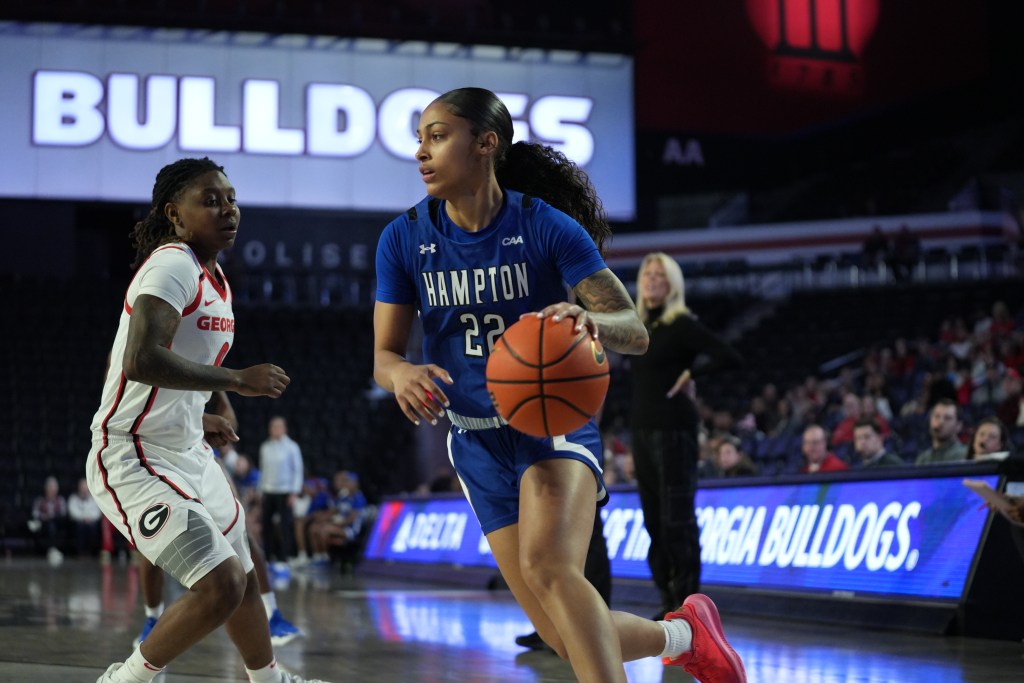 Hampton's Amiyah Reaves drives on a Georgia defender during a game on Sunday, Dec. 1, 2024. (Photo credit: Hampton Athletics)