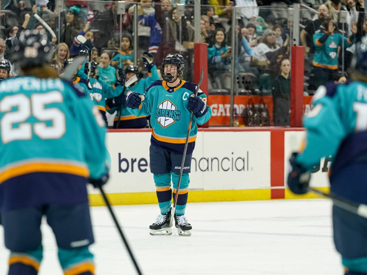 Zandee-Hart yells and pumps her fists in celebration. She is wearing a teal home uniform.