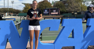 Dasha Vidmanova holds the NCAA singles trophy