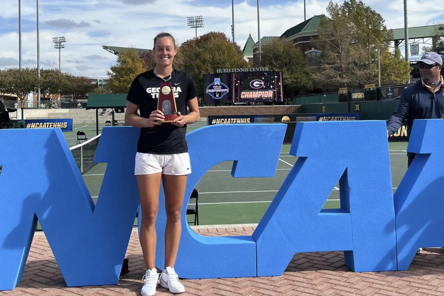 Dasha Vidmanova holds the NCAA singles trophy