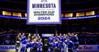 The Minnesota Frost stand beside their championship banner.