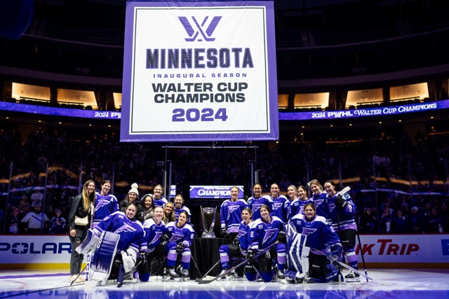 The Minnesota Frost stand beside their championship banner.