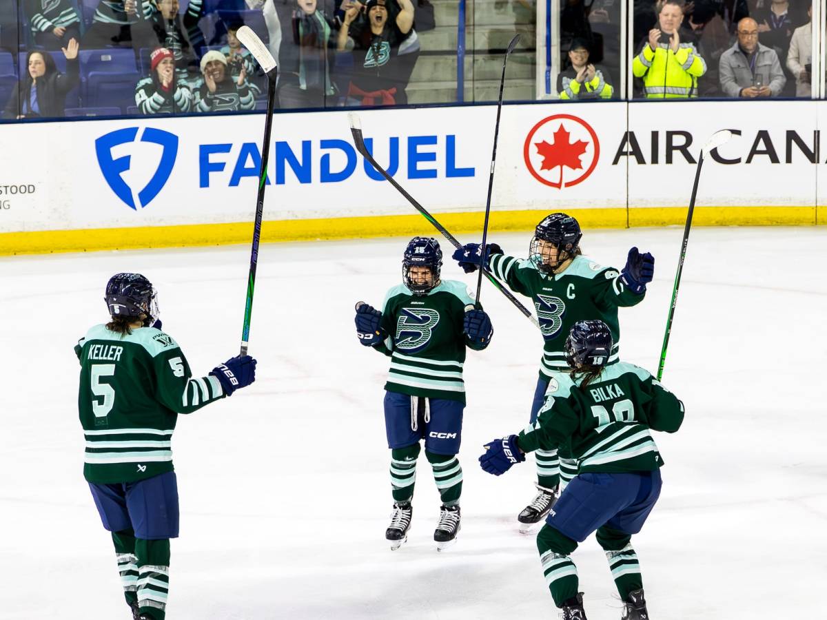 Bard yells and pumps her fist in celebrate. Keller, Knight, and Bilka all raise their arms to come in for a hug.