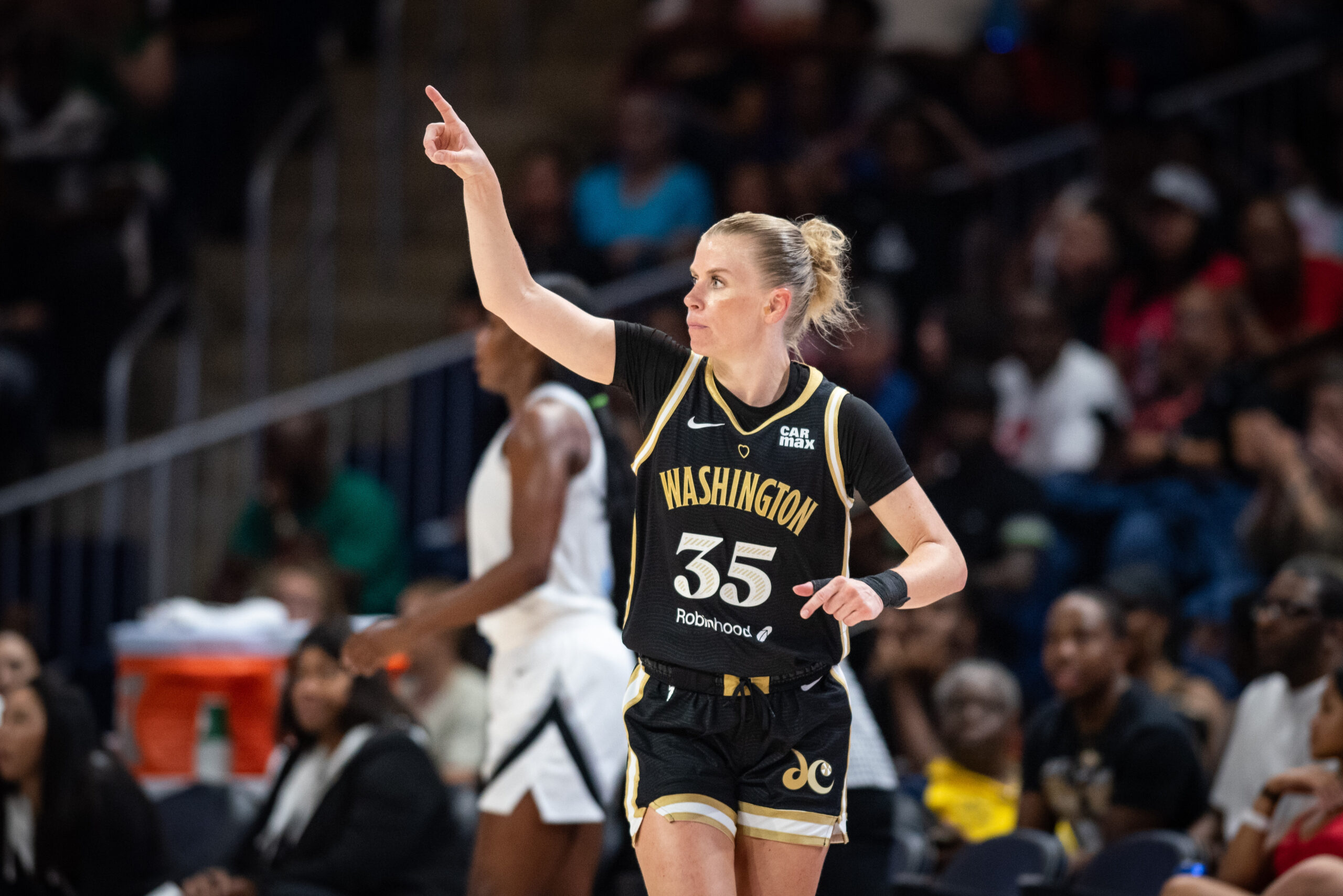 Washington Mystics guard Julie Vanloo looks to her right and raises her right pointer finger to acknowledge a teammate.