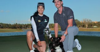 Patty Tavatanakit and Jake Knapp kneel on the green with the Grant Thornton Invitational trophy between them. A border collie dog lays between them.
