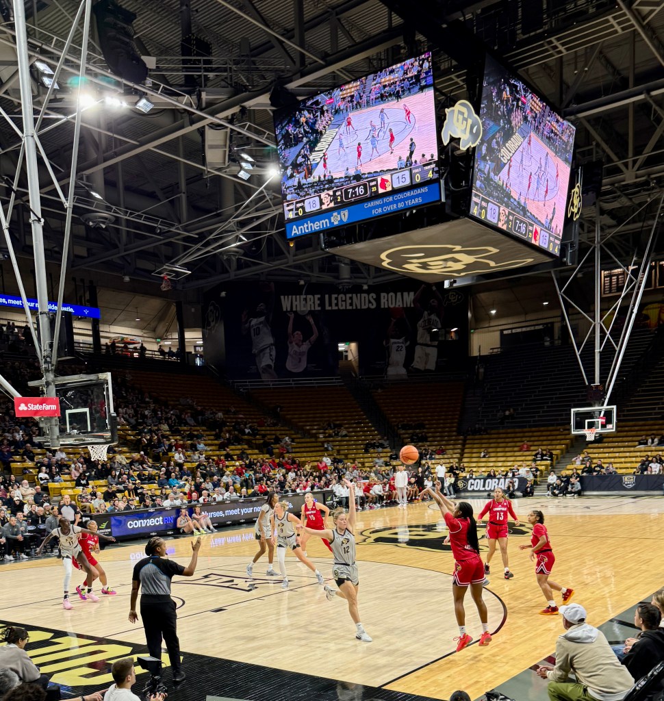 Louisville guard Izela Arenas shoots long jump shot over Lior Garzon of Colorado at a basketball game played at the Colorado Events Center.