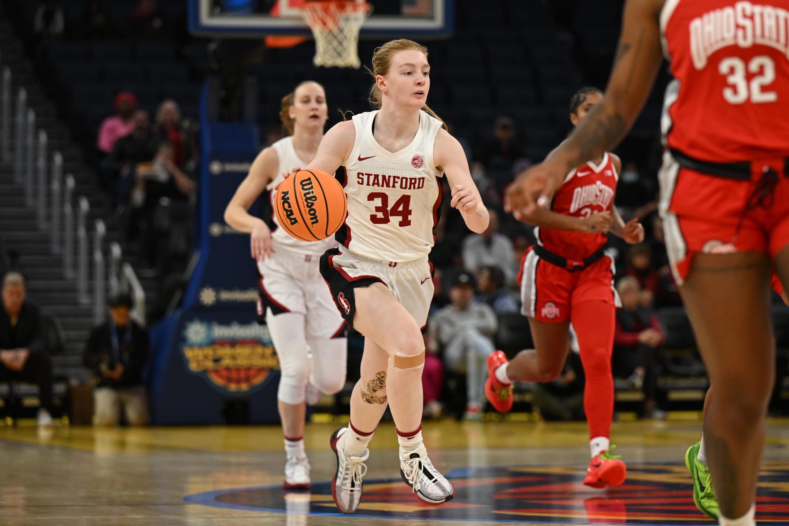 Stanford guard Tess Heal dribbles the basketball with her right hand in the open court.