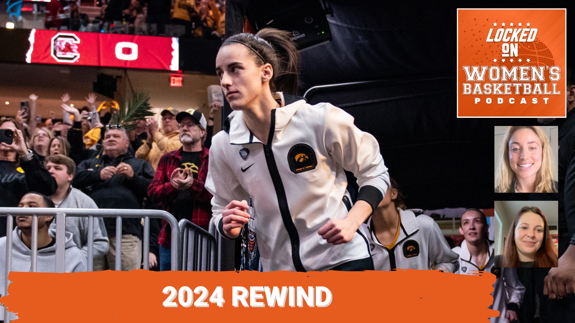 Then-Iowa guard Caitlin Clark runs onto the court for a women's basketball game. She is wearing a white Hawkeyes warmup jacket.