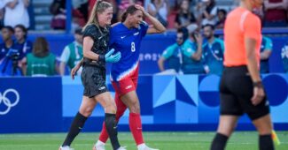 Alyssa Naeher and Lynn Williams celebrate on the field at the 2024 Paris Olympics for the USWNT.