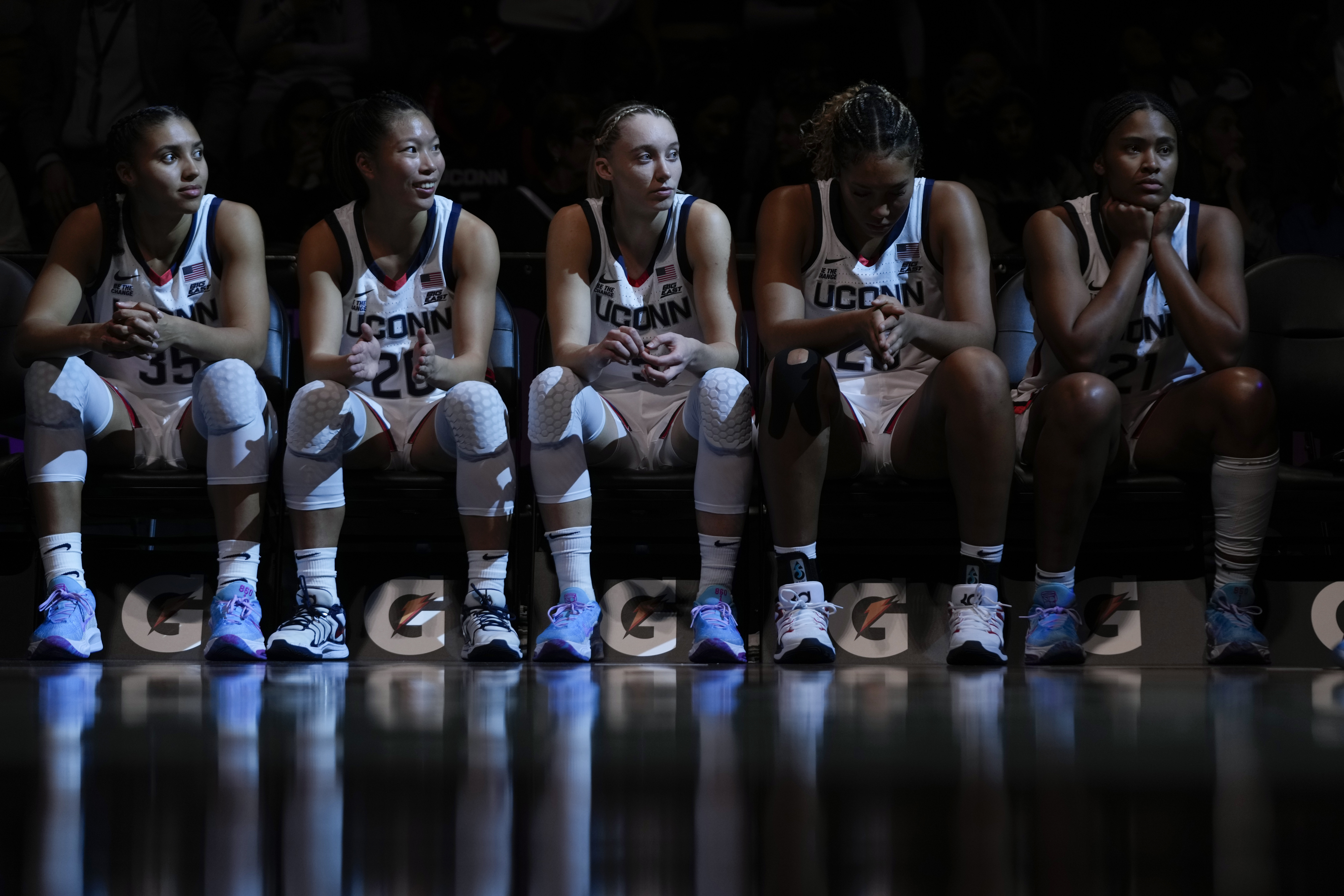 The UConn Huskies starters sit on the bench waiting for the starting lineups to be announced.