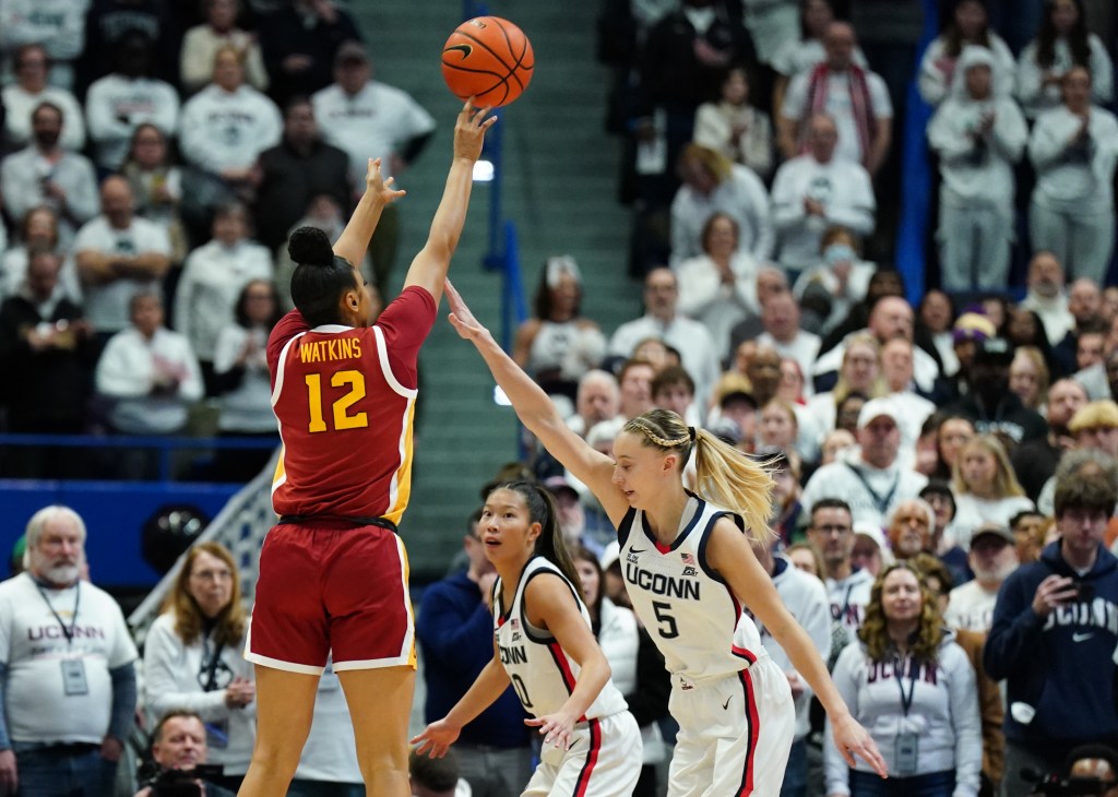 Photo of JuJu Watkins of USC shooting over UConn's Paige Bueckers.